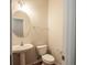 Half-bath with pedestal sink, toilet, and towel bar at 2453 Suwanee Pointe Dr, Lawrenceville, GA 30043