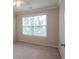 Bright bedroom featuring neutral walls and a large window, with a ceiling fan at 2453 Suwanee Pointe Dr, Lawrenceville, GA 30043