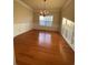 Sunlit dining room boasts hardwood floors and classic wainscoting at 2453 Suwanee Pointe Dr, Lawrenceville, GA 30043