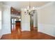 Spacious dining room with hardwood floors and elegant archway to adjacent rooms at 2453 Suwanee Pointe Dr, Lawrenceville, GA 30043