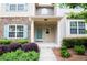 Inviting home entrance with covered porch and neatly arranged landscape at 2453 Suwanee Pointe Dr, Lawrenceville, GA 30043