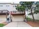 Exterior view of townhouses with attached garages and wooden decks, with lawn area on the side at 2453 Suwanee Pointe Dr, Lawrenceville, GA 30043