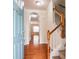 Welcoming home foyer featuring hardwood floors and a staircase to the upper level at 2453 Suwanee Pointe Dr, Lawrenceville, GA 30043