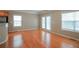 Bright living area with hardwood floors and plenty of natural light from the windows at 2453 Suwanee Pointe Dr, Lawrenceville, GA 30043
