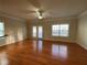 Living room with hardwood floors, ceiling fan, and access to a patio at 2453 Suwanee Pointe Dr, Lawrenceville, GA 30043