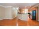Open-concept living room with hardwood floors flowing into an eat-in kitchen at 2453 Suwanee Pointe Dr, Lawrenceville, GA 30043