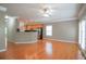 Open-concept living space with hardwood floors that flows to the kitchen and large windows at 2453 Suwanee Pointe Dr, Lawrenceville, GA 30043