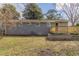 Exterior view of home from backyard, featuring a wooden deck and a well-maintained lawn at 2973 Cambridge Sw Dr, Atlanta, GA 30331