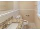 Well lit bathroom featuring a granite countertop, toilet, mirror, and neutral color scheme at 2973 Cambridge Sw Dr, Atlanta, GA 30331