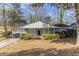 Charming gray brick home with a well-manicured lawn and lush greenery at 2973 Cambridge Sw Dr, Atlanta, GA 30331