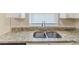 Close up of a double stainless sink and granite countertop in the kitchen at 2973 Cambridge Sw Dr, Atlanta, GA 30331