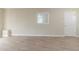 Neutral living room with wood-look flooring, window, and a white door at 2973 Cambridge Sw Dr, Atlanta, GA 30331