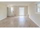 Bright living room with wood-look flooring, a large window, and neutral walls at 2973 Cambridge Sw Dr, Atlanta, GA 30331