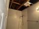 Bathroom shower with tile and open ceiling with exposed rafters at 8229 Queens Dr, Jonesboro, GA 30238