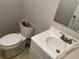 Modest bathroom featuring a sink with a vanity and open toilet at 8229 Queens Dr, Jonesboro, GA 30238