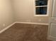 Cozy bedroom with neutral paint, and a window allowing natural light at 8229 Queens Dr, Jonesboro, GA 30238
