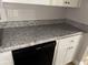 Kitchen counter and cabinets. A black dishwasher is installed and ready to use at 8229 Queens Dr, Jonesboro, GA 30238