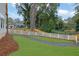 Expansive backyard with a well-manicured lawn, white fence, and a gravel path at 830 Gaston Street Sw, Atlanta, GA 30310