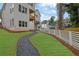 Exterior of a home with a green lawn, stone path, and a white fence at 830 Gaston Street Sw, Atlanta, GA 30310