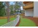 The backyard offers a private space with its lush lawn, landscaping, and charming white fence at 830 Gaston Street Sw, Atlanta, GA 30310