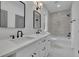 Bright bathroom featuring double vanity, modern fixtures, framed mirrors and tiled shower at 830 Gaston Street Sw, Atlanta, GA 30310