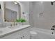 Stylish bathroom with white cabinets, gold hardware, and a tiled shower-tub at 830 Gaston Street Sw, Atlanta, GA 30310