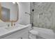 Bathroom with white vanity, modern fixtures, framed mirror, tiled shower, and bath at 830 Gaston Street Sw, Atlanta, GA 30310