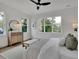 This neutral bedroom has a large window, bench, light wood floors, and a calming atmosphere at 830 Gaston Street Sw, Atlanta, GA 30310