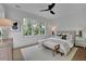 Bright bedroom features a large window, white plank wall, fan, and a comfortable neutral color scheme at 830 Gaston Street Sw, Atlanta, GA 30310