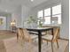 Bright dining room features wood floors, a large window, and a black table with seating for four at 830 Gaston Street Sw, Atlanta, GA 30310