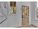 Bright entryway featuring a windowed wooden door, white trim, and hardwood floors at 830 Gaston Street Sw, Atlanta, GA 30310
