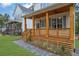 Inviting front porch with wooden columns and a cozy seating area at 830 Gaston Street Sw, Atlanta, GA 30310