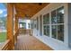 Inviting covered porch with wood flooring, columns, and natural light at 830 Gaston Street Sw, Atlanta, GA 30310