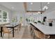 Open concept kitchen with a long island and a bright dining area with a black table at 830 Gaston Street Sw, Atlanta, GA 30310