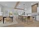 Open concept kitchen with a long island and a dining area with a dark wood table at 830 Gaston Street Sw, Atlanta, GA 30310