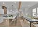 Open concept kitchen and dining area featuring an island with seating and hardwood floors at 830 Gaston Street Sw, Atlanta, GA 30310