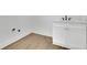 Laundry room with wood floors and white cabinets, offering a functional and clean space at 830 Gaston Street Sw, Atlanta, GA 30310