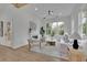 Bright living room with hardwood floors, a modern fireplace, and comfortable seating, with a view to the sunroom at 830 Gaston Street Sw, Atlanta, GA 30310
