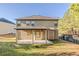A view of the home's backyard with a covered patio and a grassy lawn at 2154 Dodson Woods Dr, Fairburn, GA 30213