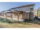 View of home's backyard featuring a covered patio and spacious grassy lawn at 2154 Dodson Woods Dr, Fairburn, GA 30213
