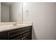 Bathroom vanity with light beige countertop, dark cabinets, towel ring, and large mirror at 2154 Dodson Woods Dr, Fairburn, GA 30213
