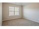 Bedroom with neutral walls, large window, and carpet flooring at 2154 Dodson Woods Dr, Fairburn, GA 30213