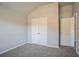 Bright bedroom with carpet, closet doors, and neutral paint at 2154 Dodson Woods Dr, Fairburn, GA 30213