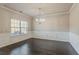 Formal dining room featuring hardwood floors, wainscoting, and a chandelier at 2154 Dodson Woods Dr, Fairburn, GA 30213