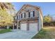 Beautiful two-story home featuring a brick facade, attached two-car garage, and manicured lawn at 2154 Dodson Woods Dr, Fairburn, GA 30213