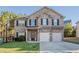 Charming two-story brick home with a well-manicured lawn and a two-car garage at 2154 Dodson Woods Dr, Fairburn, GA 30213