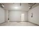 Spacious garage with concrete floor, overhead lights and an access door at 2154 Dodson Woods Dr, Fairburn, GA 30213