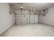 Two-car garage with doors and smooth concrete floor at 2154 Dodson Woods Dr, Fairburn, GA 30213