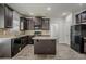 Modern kitchen with dark wood cabinets, granite countertops, and stainless steel appliances at 2154 Dodson Woods Dr, Fairburn, GA 30213