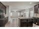 Open concept kitchen with a center island, dark cabinets, and views into the living area at 2154 Dodson Woods Dr, Fairburn, GA 30213